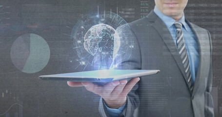 Image of globe, statistics and financial data processing over businessman holding tablet