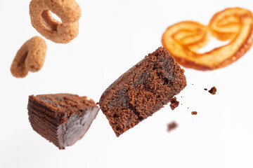 Chocolate brownies dessert with pieces in flight on white background, dessert concept