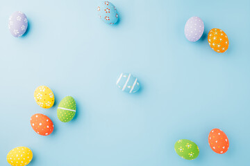 Colorful easter eggs isolated on blue background with copy space, Funny decoration, Creative composition banner web design holiday background, Happy Easter Day greeting card, flat lay top view