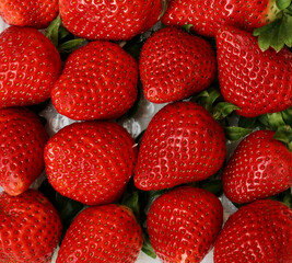 Full frame close up image of abundant lush red strawberries