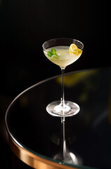 Classic cocktail glass on glass table in nightclub restaurant.