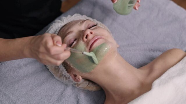 Facial brush, modern cosmetology, Acid peeling. Modern cosmetology procedure with an enzyme mask, retinol treatment with facial brush peel procedure, enzyme peeling for beauty woman