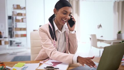 Phone call, fashion designer woman and friendly discussion for logistics, small business startup or b2b in ecommerce. Creative clothes seller or Indian person multitasking on cellphone and laptop