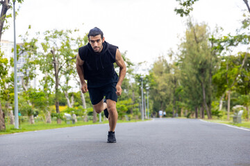 Handsome Caucasian man jogger in sportswear jogging exercise at public park in summer morning. Healthy guy athlete enjoy outdoor activity lifestyle sport training fitness running workout in the city.