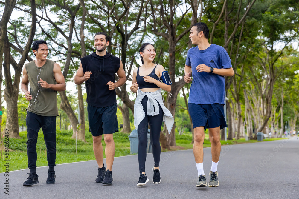 Wall mural group of man and woman friends in sportswear jogging exercise together at public park in the morning