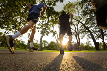 Group of Diversity Men friends in sportswear jogging exercise together at public park in the...