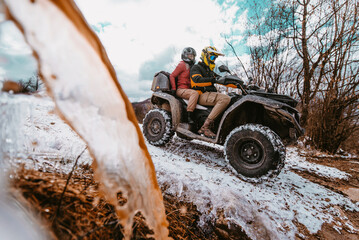 People enjoying while driving quad bike on top of mountain at winter time © Minet