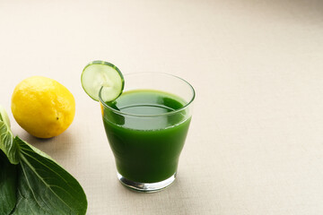 A glass of Green Juice, made from organic pakcoy, cucumber and lemon, very good for health. Cold Pressed Juice
