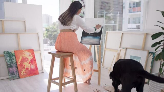 Dog, painter or woman painting on canvas in art gallery room or studio with watercolor or paint brush. Focus, pet animal or artistic girl drawing or relaxing in creative, calm or peaceful workshop