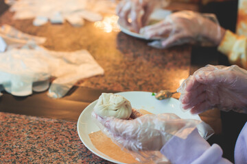 Group of children in a cooking class, kids preparing asian style food in the kitchen together, kids in aprons learn cooking on master class, chef uniform, hands in gloves