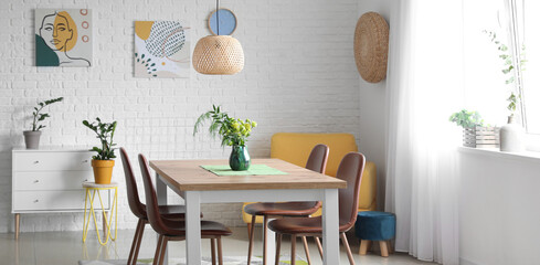 Interior of modern light dining room with big table