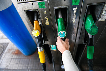  A person using a petrol pump (unleaded fuel, 