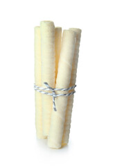 Delicious wafer rolls tied by string isolated on white background