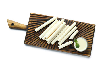 Board with delicious wafer rolls, bowl of condensed milk and mint isolated on white background