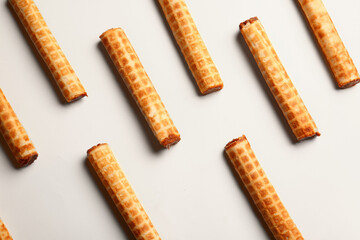 Many wafer rolls with boiled condensed milk on white background