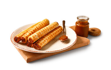 Plate of delicious wafer rolls with boiled condensed milk isolated on white background