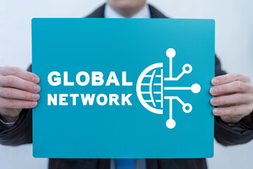 Businessman holding turquoise banner with inscription: GLOBAL NETWORK. Concept of global network,...