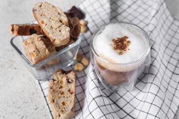 Delicious biscotti cookies and cup of coffee on napkin