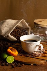 Obraz na płótnie Canvas Cup of coffee with beans, lemon and peach