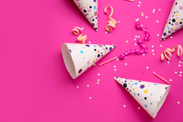 Composition with party hats, birthday candles and confetti on color background