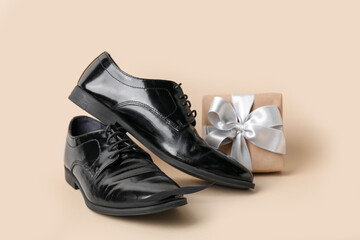 Stylish male shoes and gift for Father's Day celebration on color background