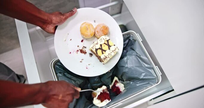 Throwing Away Leftover Food In Trash