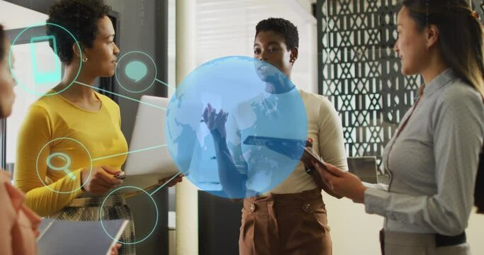 Animation of globe with icons over diverse business people talking in office