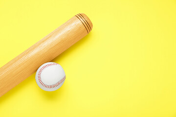 Wooden baseball bat and ball on yellow background, flat lay. Space for text