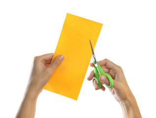 Woman cutting yellow paper with scissors on white background, closeup