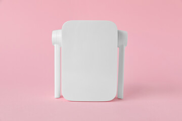 New modern Wi-Fi repeater on pink background