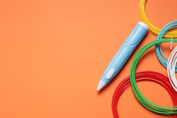 Stylish 3D pen and colorful plastic filaments on orange background, flat lay. Space for text