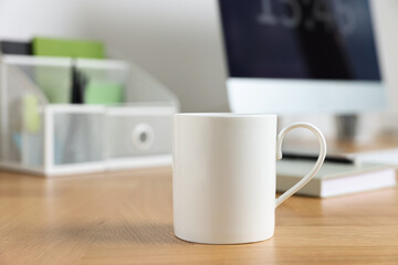 Blank ceramic mug on wooden table. Mockup for design