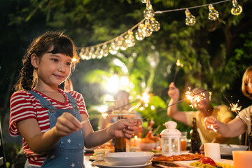 Attractive young child looking at camera while having party outdoor.