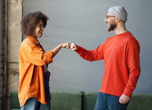 Smiling Emotional Business Colleagues, Coworkers Greeting, Give First Bump. Two Happy Friends Communication Together. Meeting, Teamwork Concept 