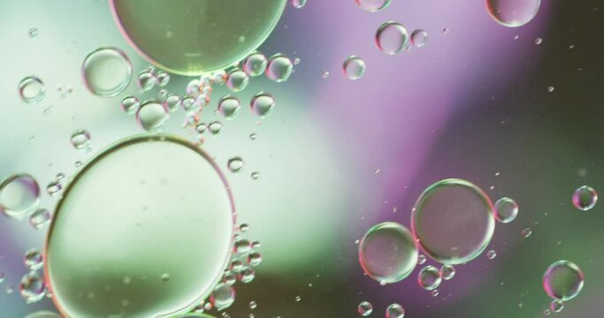 Animation of bubbles moving on green and pink background with copy space
