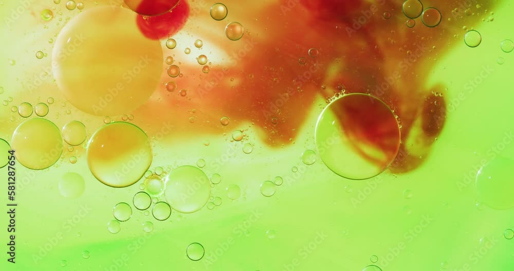 Poster animation of bubbles moving on green and red liquid with copy space