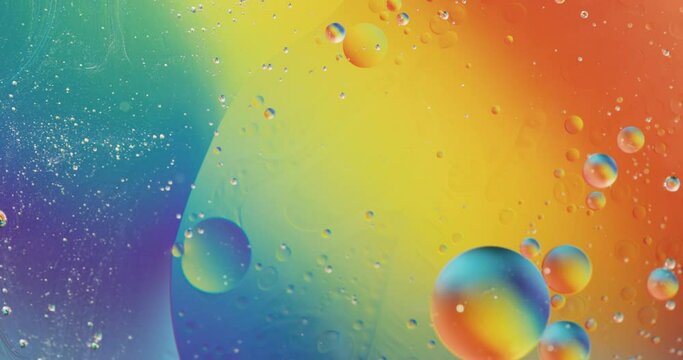 Animation of bubbles moving on blue and yellow liquid with copy space