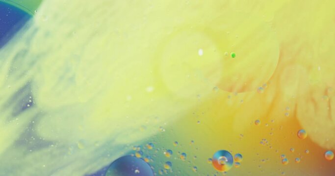 Animation of bubbles moving on blue and yellow background with copy space