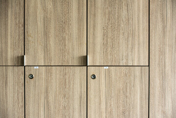 Wooden lockers with key in locker room at school sport club office.