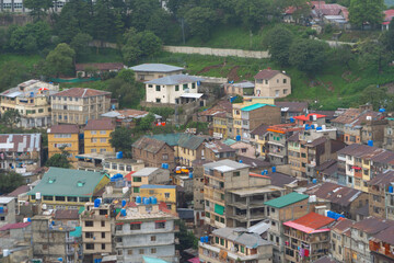 Aerial top view of Muree village, Islamabad with residential local houses, nature trees, Pakistan in urban city town in Asia, buildings.