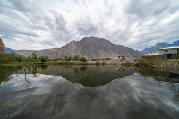 A pond river lake in Karakoram high mountain hills. Nature landscape background, Skardu-Gilgit, Pakistan. Travel on holiday vacation.