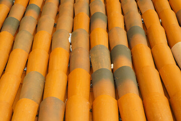Old tiled roof in orange color close up