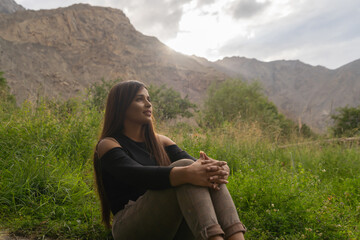 A Pakistani woman tourist travel in Karakoram high mountain hills. Nature landscape background, Skardu-Gilgit, Pakistan. Travel on holiday vacation. People lifestyle.