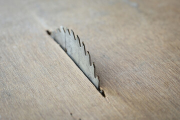 sharp metal saw on wood plank texture background, construction machine