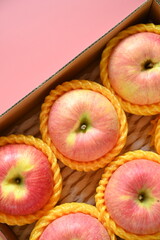 beautiful pink apple in the box on pink background