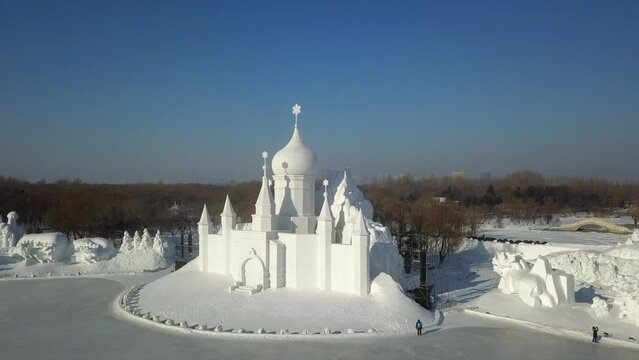 Ornate domed building sculpture in snow and ice in winter city, Harbin