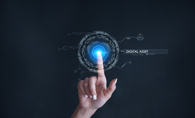 Finger touching some holographic graphic user interface with digital asset technology concepts.