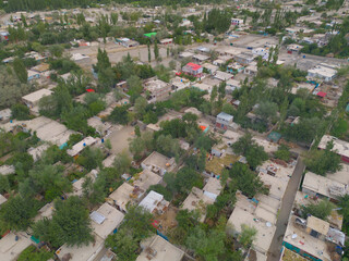 Obraz premium Aerial top view of Muree village, Islamabad with residential local houses and fog mist, nature trees, Pakistan in urban city town in Asia, buildings.