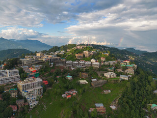 Aerial top view of Muree village, Islamabad with residential local houses and fog mist, nature trees, Pakistan in urban city town in Asia, buildings.