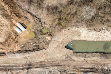 laying or replacement of underground storm sewer pipes. construction site. aerial top view.
